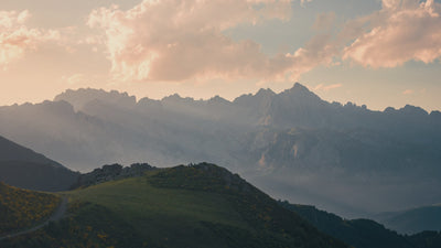 Sunrise over a quiet mountain range, capturing the stillness and God-breathed beauty that inspires Abellé’s hand-painted Christian jewelry.